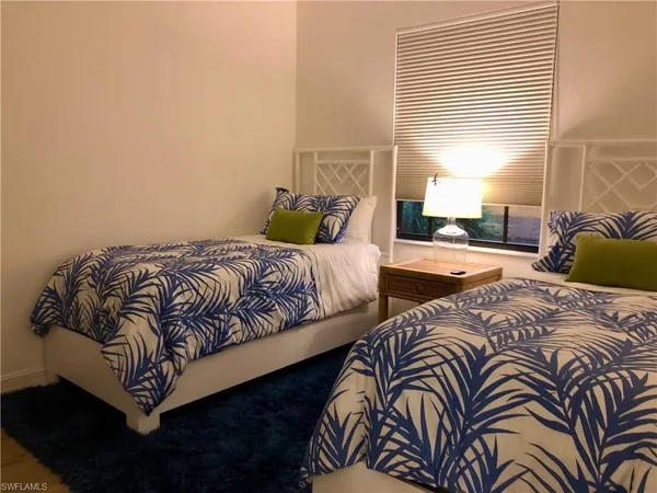 a bedroom with bed and a window