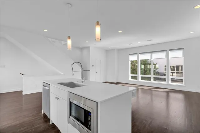 a view of a kitchen with a sink and a large window
