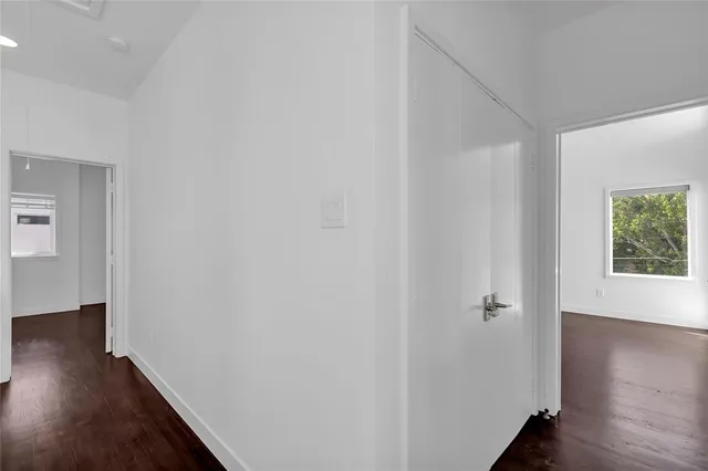 a view of a hallway with wooden floor