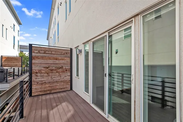 a view of walk in closet with wooden floor