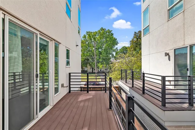 a view of a balcony with chairs and wooden floor