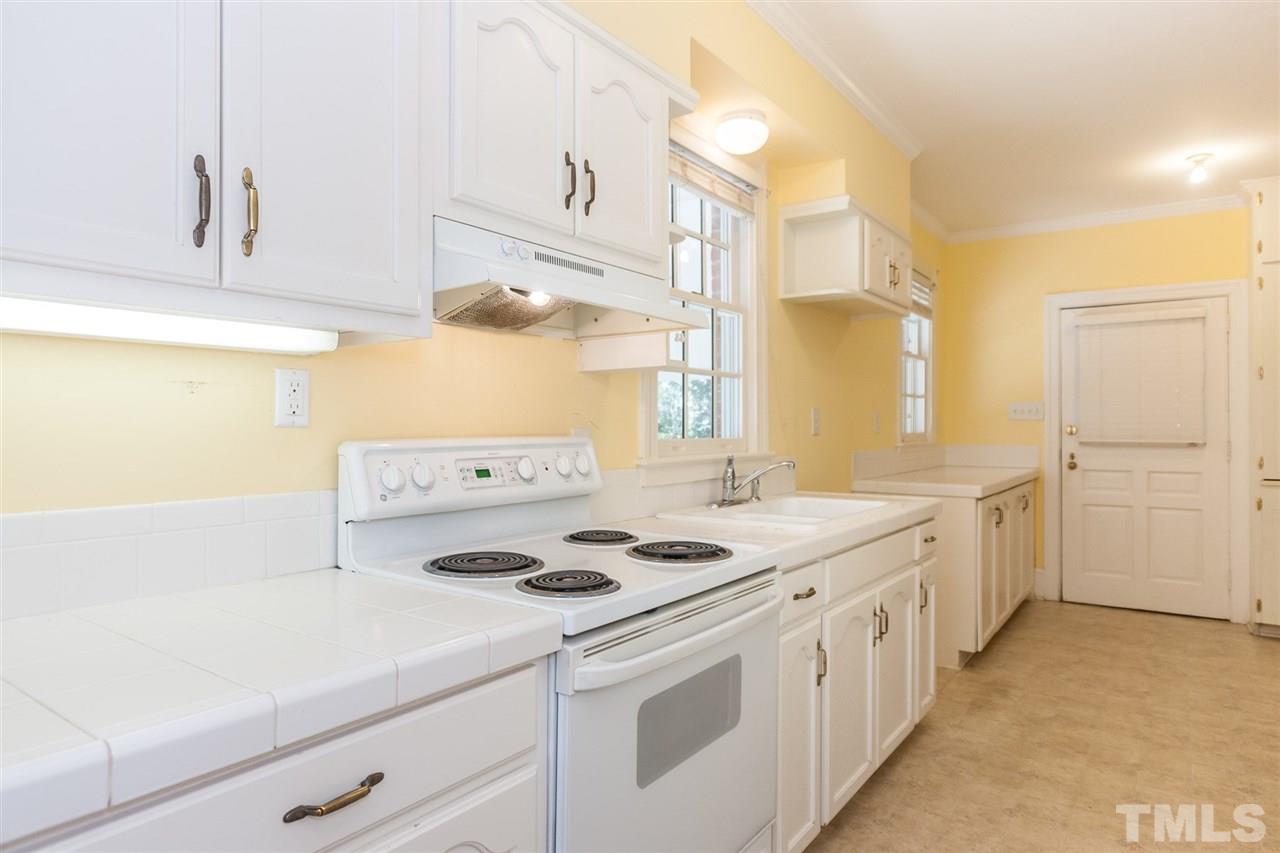 1707 Jarvis Street Raleigh, NC 27608 - Photo 11 of 25 a kitchen with appliances cabinets and a counter top space