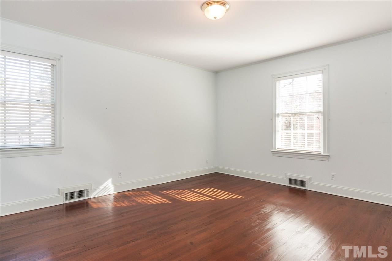 1707 Jarvis Street Raleigh, NC 27608 - Photo 15 of 25 an empty room with wooden floor and windows