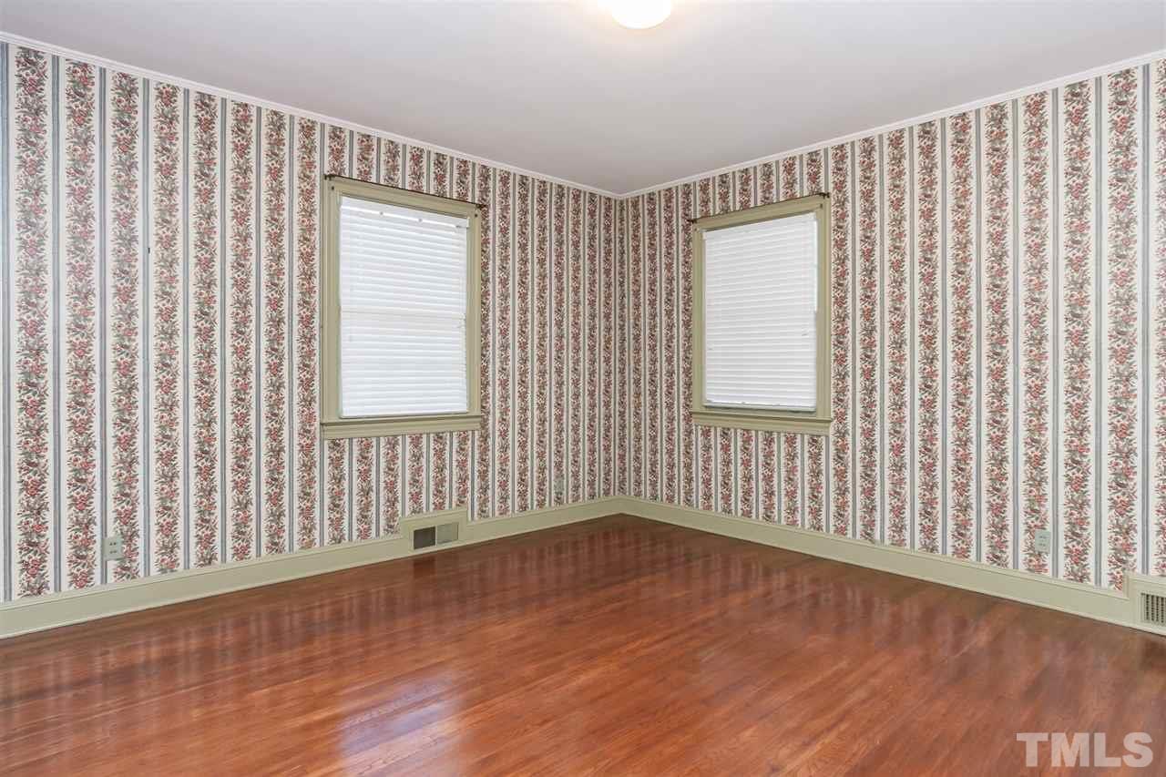 1707 Jarvis Street Raleigh, NC 27608 - Photo 17 of 25 a view of an empty room with wooden floor and a window