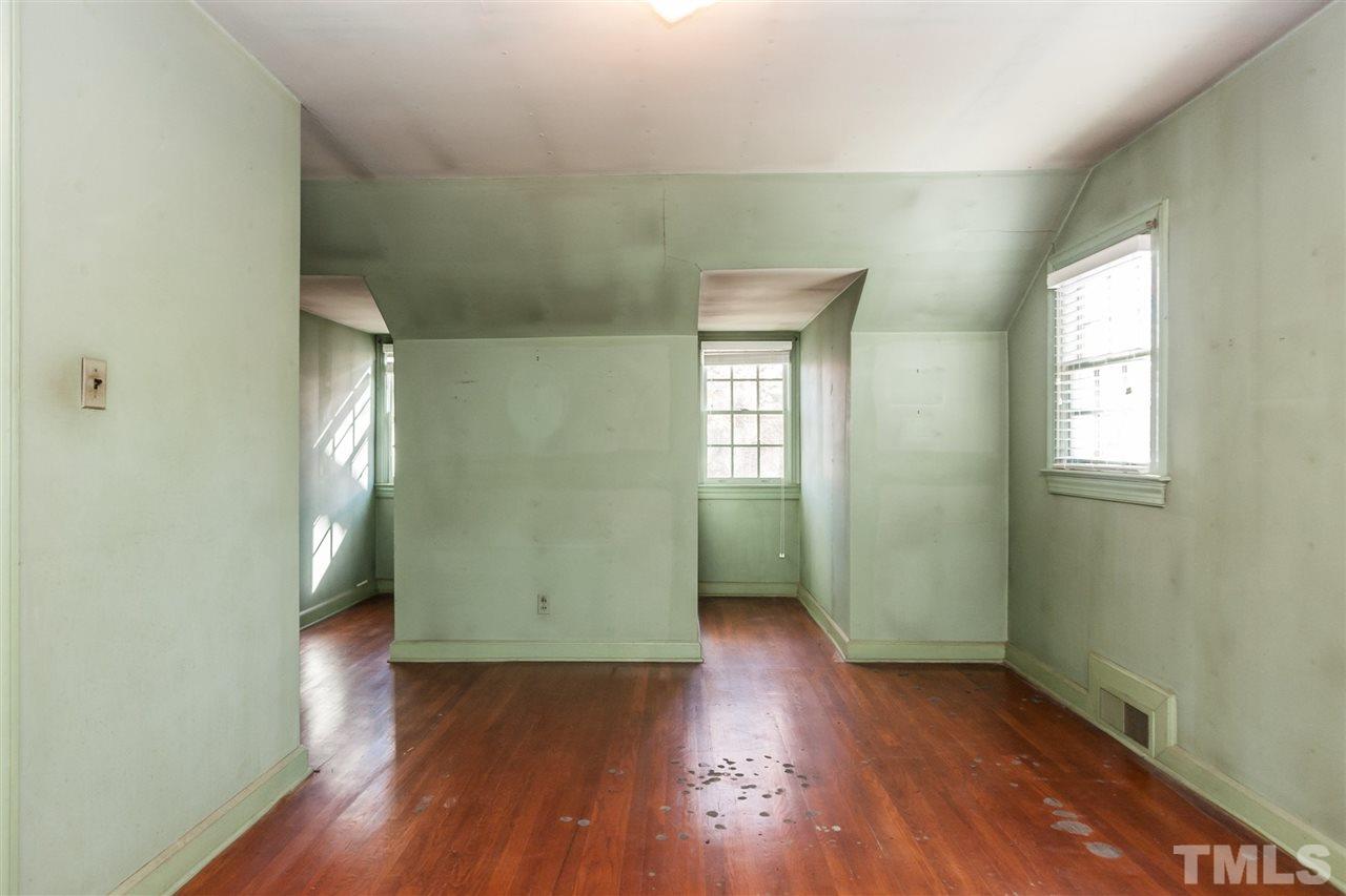 1707 Jarvis Street Raleigh, NC 27608 - Photo 20 of 25 an empty room with wooden floor and windows