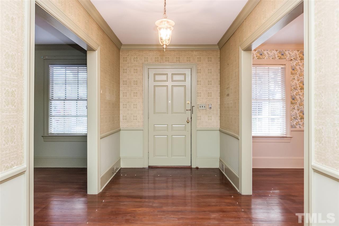 1707 Jarvis Street Raleigh, NC 27608 - Photo 3 of 25 an empty room with wooden floor cabinet and windows