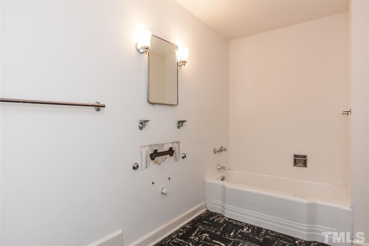 1707 Jarvis Street Raleigh, NC 27608 - Photo 21 of 25 a bathroom with a bathtub and shower