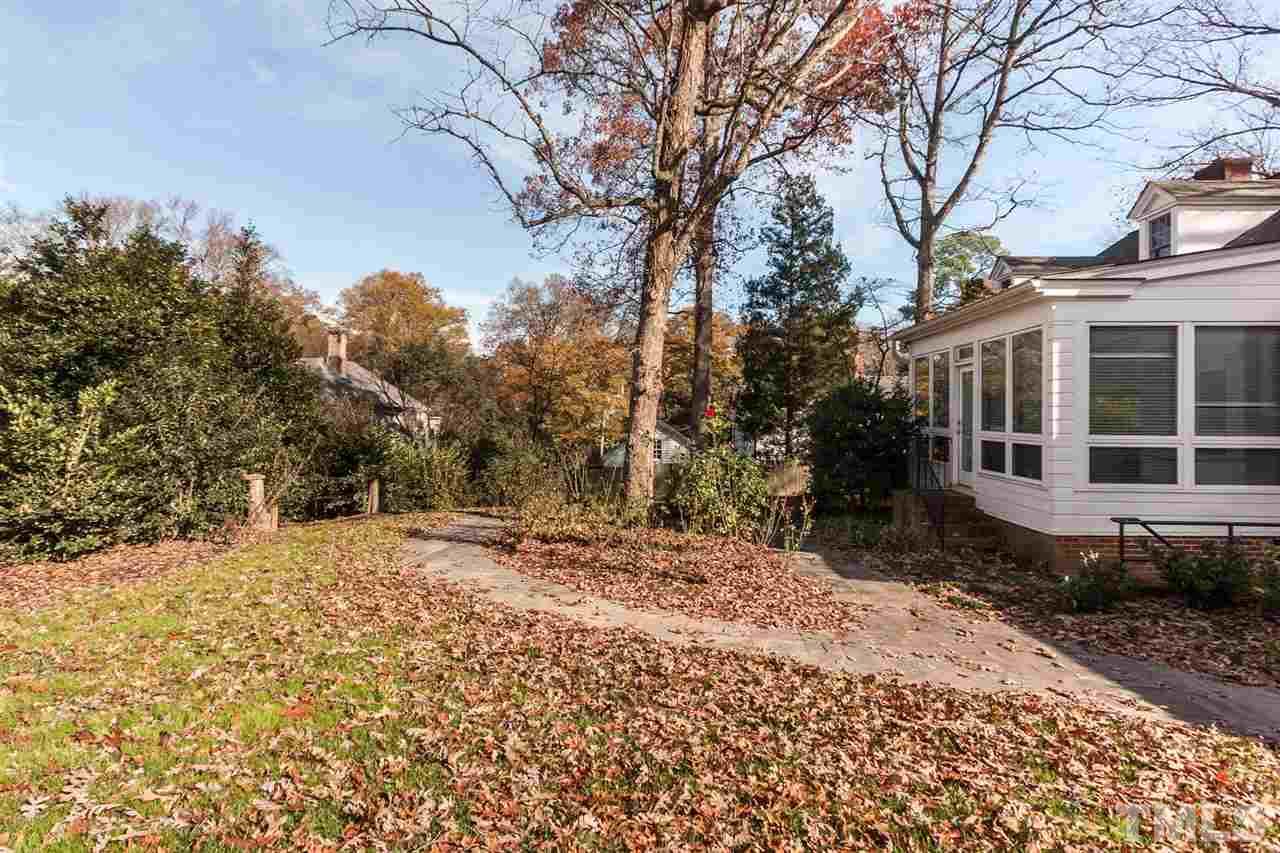 1707 Jarvis Street Raleigh, NC 27608 - Photo 22 of 25 a view of a house with a yard covered in snow
