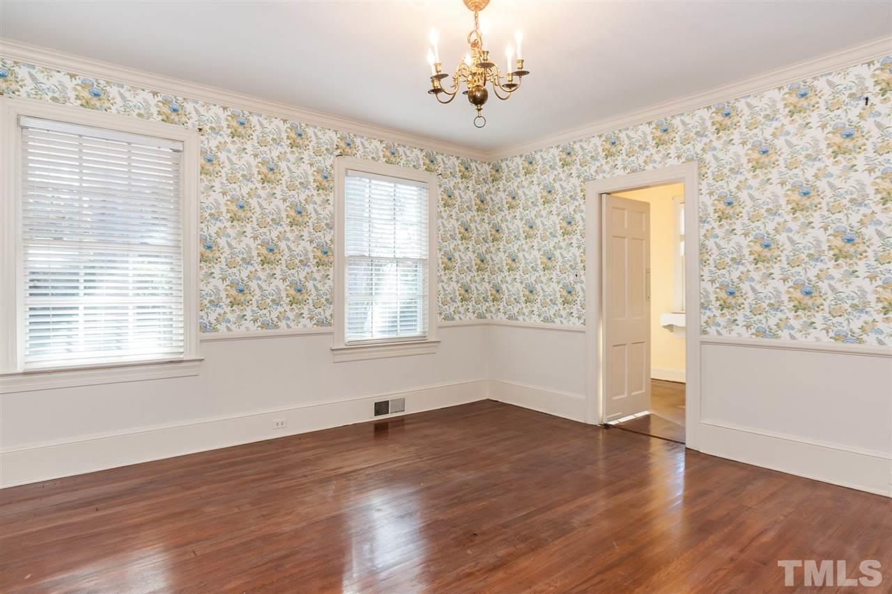 1707 Jarvis Street Raleigh, NC 27608 - Photo 4 of 25 a view of an empty room with wooden floor and a window
