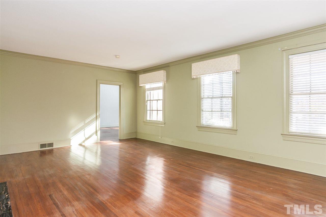 1707 Jarvis Street Raleigh, NC 27608 - Photo 6 of 25 an empty room with wooden floor and windows