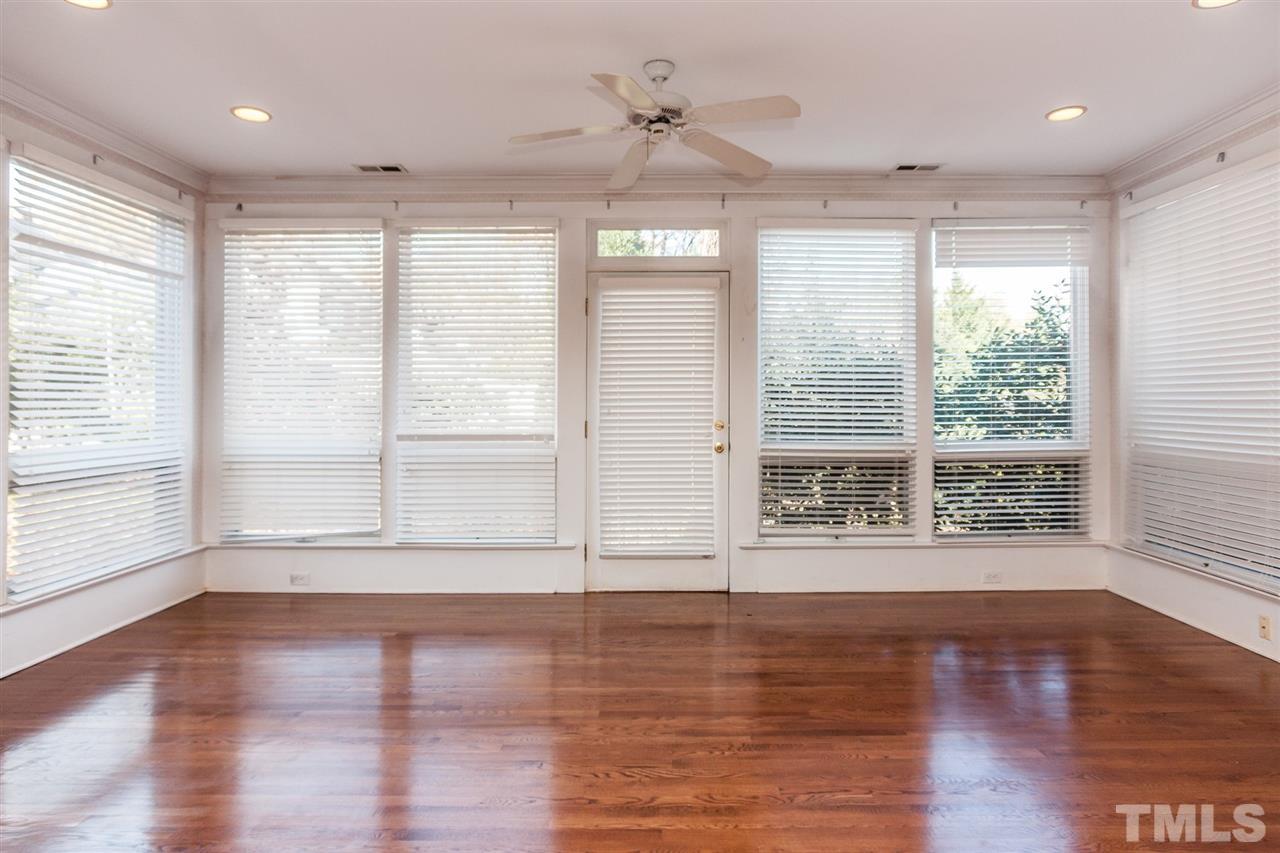 1707 Jarvis Street Raleigh, NC 27608 - Photo 9 of 25 a view of an empty room with wooden floor and a window