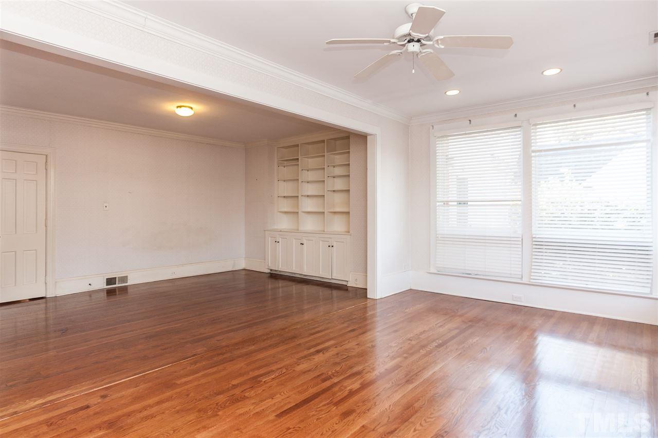 1707 Jarvis Street Raleigh, NC 27608 - Photo 10 of 25 a view of an empty room with a window and wooden floor