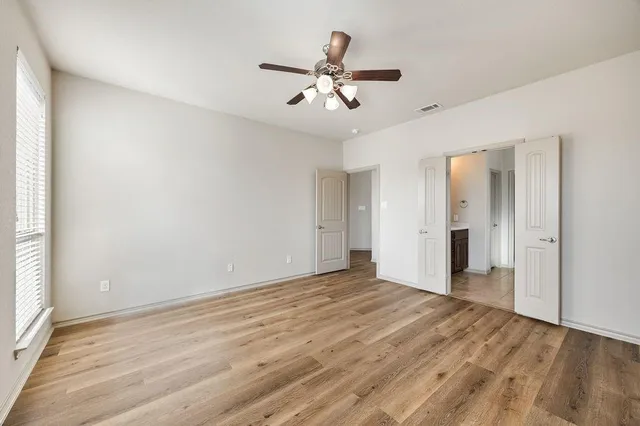a bathroom with a tub a double vanity sink and mirror