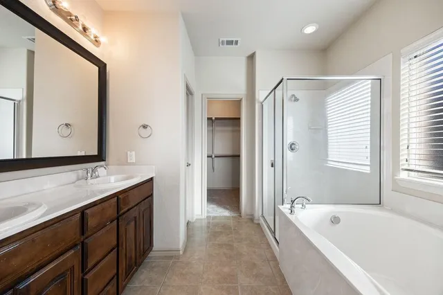 a bathroom with a tub and shower