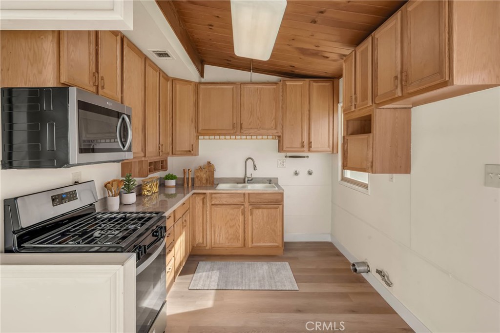 716 East Hanks Street Azusa, CA 91702 - Photo 5 of 14 a kitchen with a sink a stove and cabinets