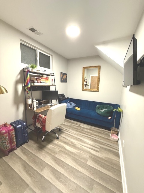 2115 West Barry Avenue, Unit CH Chicago, IL 60618 - Photo 9 of 15 a bedroom with a bed and flat screen tv