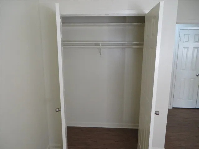 a view of walk in closet with empty racks