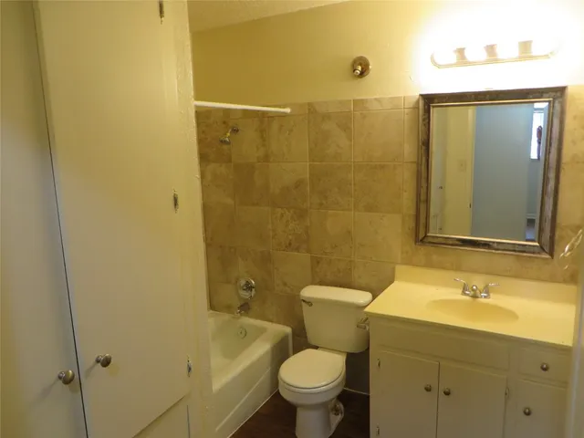 a bathroom with a sink mirror toilet and shower