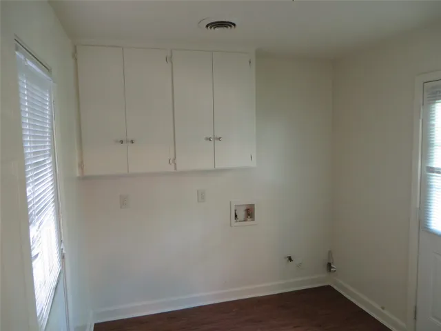 a view of an empty room and wooden floor