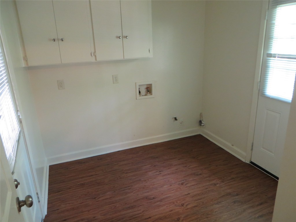 812 Ranch Road, Unit B Georgetown, TX 78628 - Photo 26 of 31 an empty room with wooden floor and windows