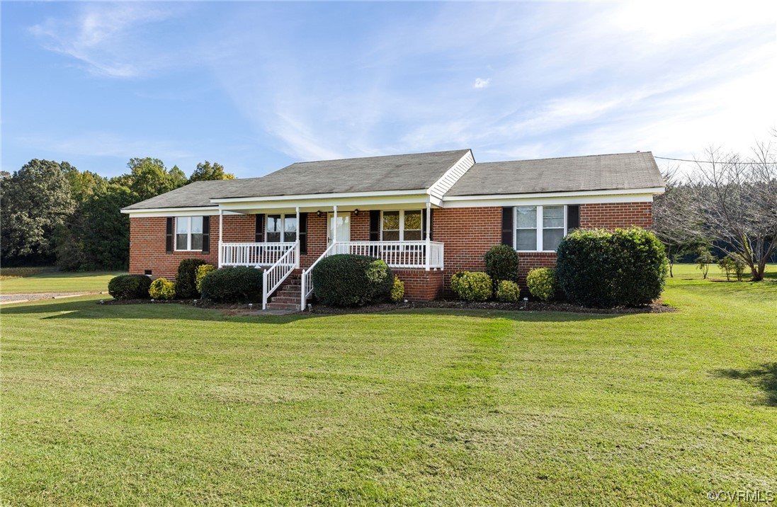 a front view of house with yard and trees