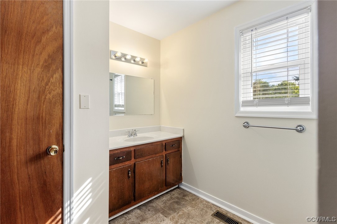 4540 Powhatan Lakes Road Powhatan, VA 23139 - Photo 15 of 23 a bathroom with a sink and a mirror