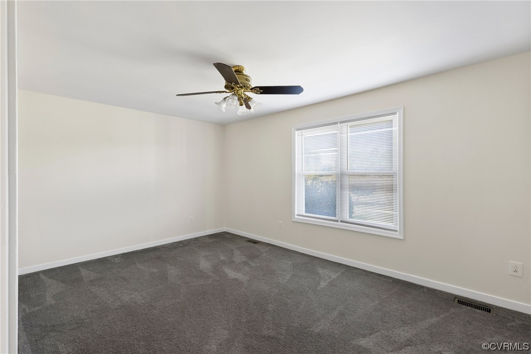 4540 Powhatan Lakes Road Powhatan, VA 23139 - Photo 17 of 23 an empty room with a window and a ceiling fan