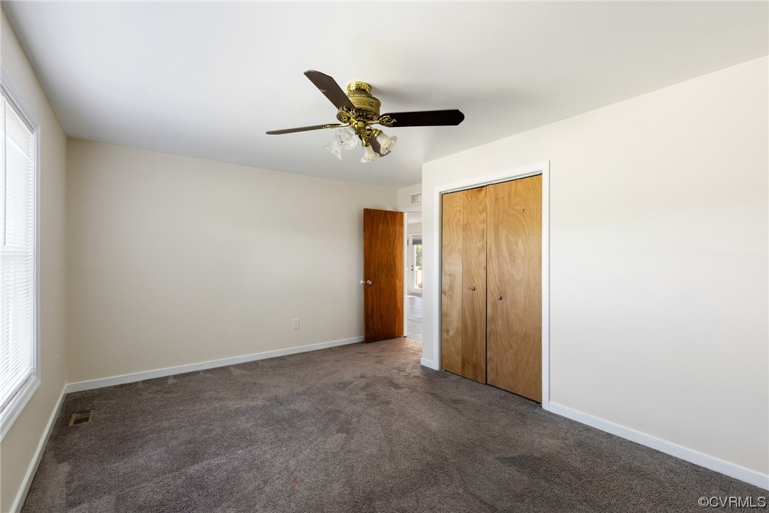 4540 Powhatan Lakes Road Powhatan, VA 23139 - Photo 18 of 23 an empty room with a ceiling fan and window