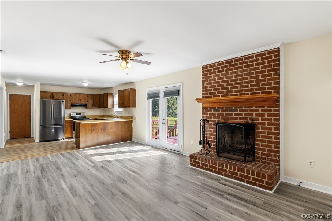 4540 Powhatan Lakes Road Powhatan, VA 23139 - Photo 3 of 23 a view of kitchen with granite countertop a stove top oven and a fireplace