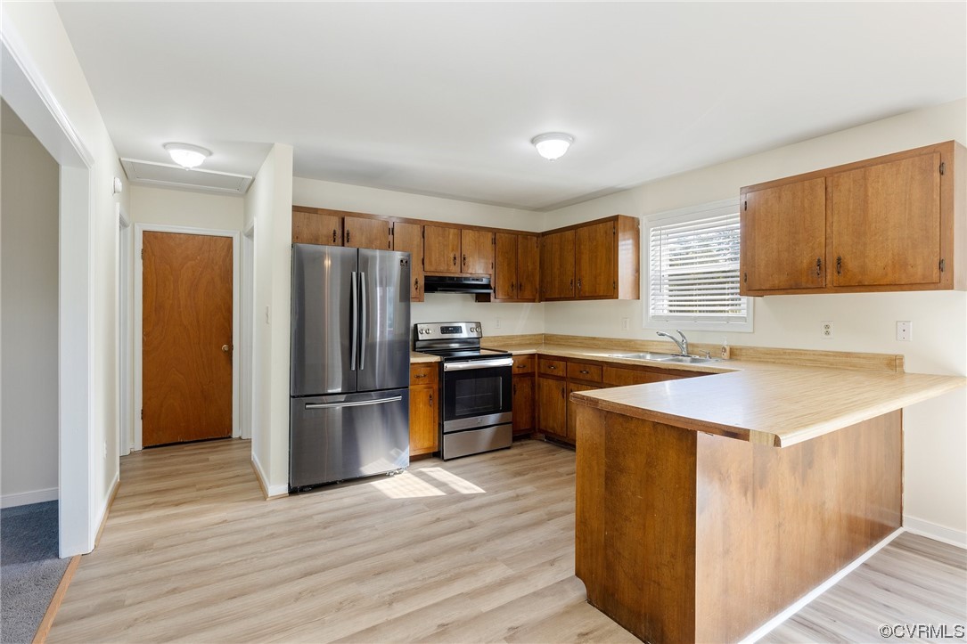 4540 Powhatan Lakes Road Powhatan, VA 23139 - Photo 5 of 23 a kitchen with a refrigerator stove and wooden cabinets
