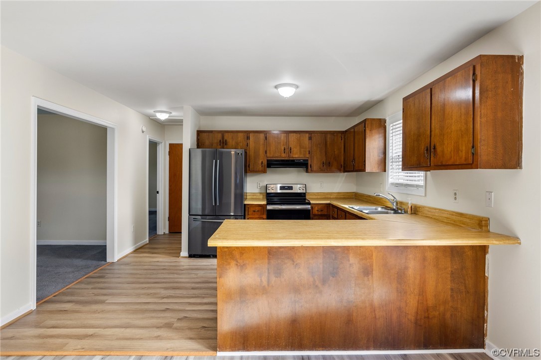 4540 Powhatan Lakes Road Powhatan, VA 23139 - Photo 6 of 23 a kitchen with wooden cabinets a sink and dishwasher