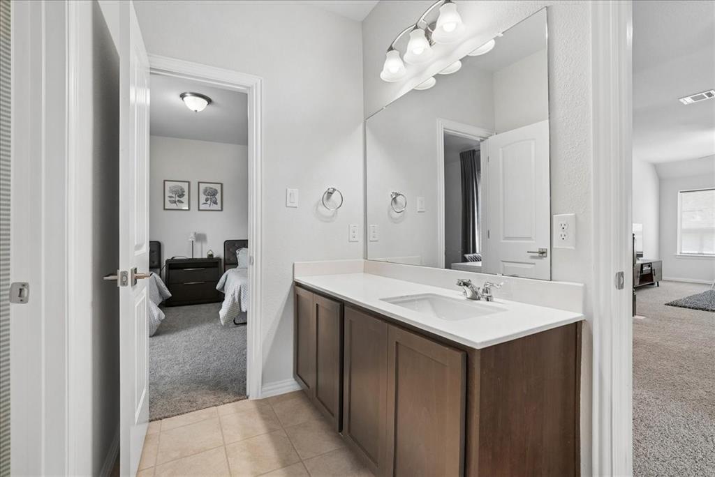 2721 Rotherham Street Prosper, TX 75078 - Photo 22 of 37 a en suite bathroom with a double vanity sink and a mirror