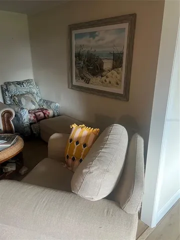 a living room with furniture and a painting on the wall