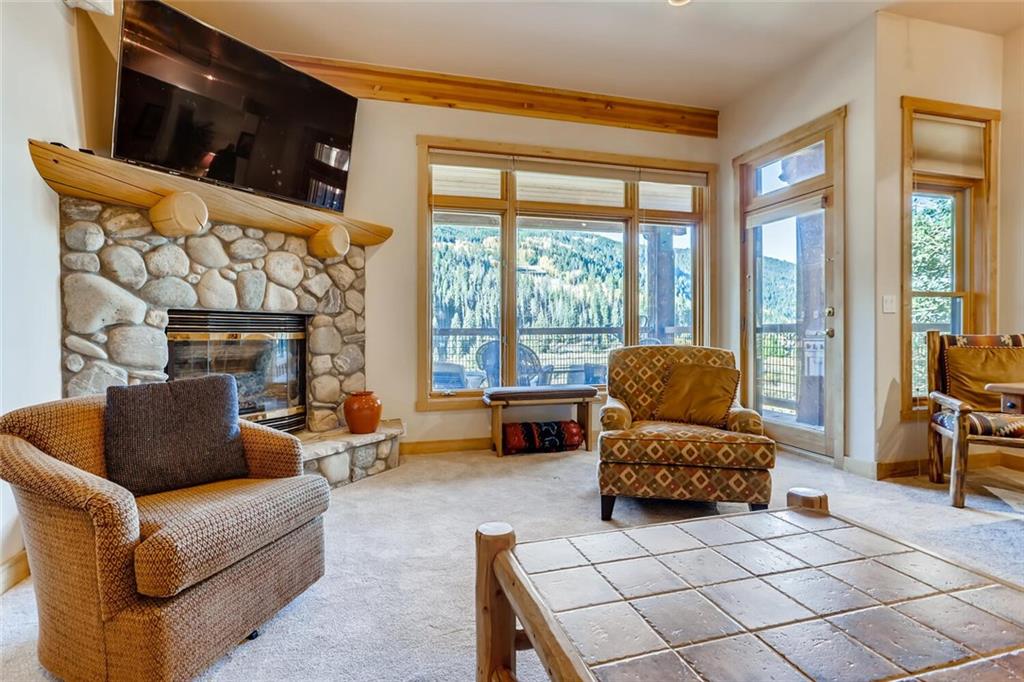 56 River Run Road, Unit 301 Keystone, CO 80435 - Photo 2 of 30 a living room with furniture and a fireplace