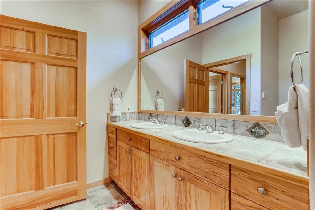 56 River Run Road, Unit 301 Keystone, CO 80435 - Photo 16 of 30 a bathroom with a double vanity sink and a mirror