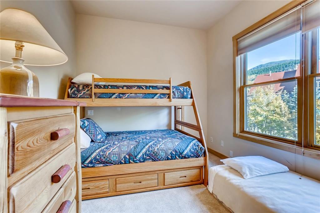 56 River Run Road, Unit 301 Keystone, CO 80435 - Photo 18 of 30 a bedroom with a bed and window