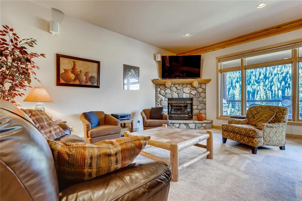 56 River Run Road, Unit 301 Keystone, CO 80435 - Photo 3 of 30 a living room with furniture and a fireplace