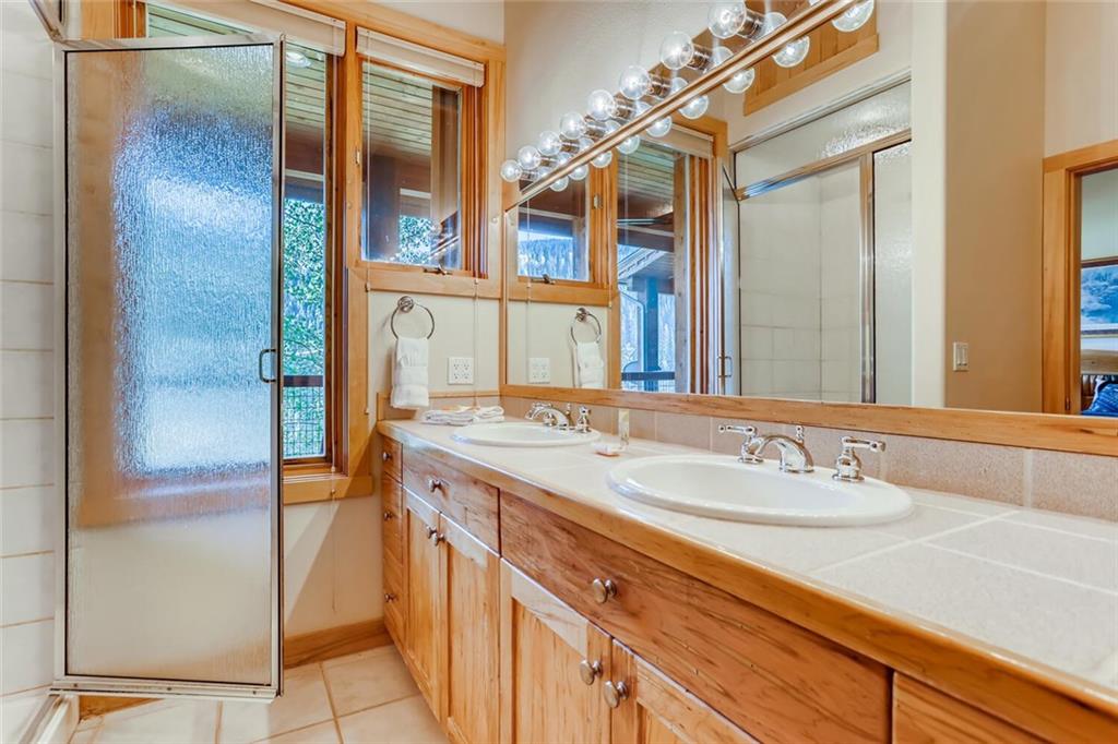 56 River Run Road, Unit 301 Keystone, CO 80435 - Photo 21 of 30 a bathroom with a granite countertop sink and a mirror