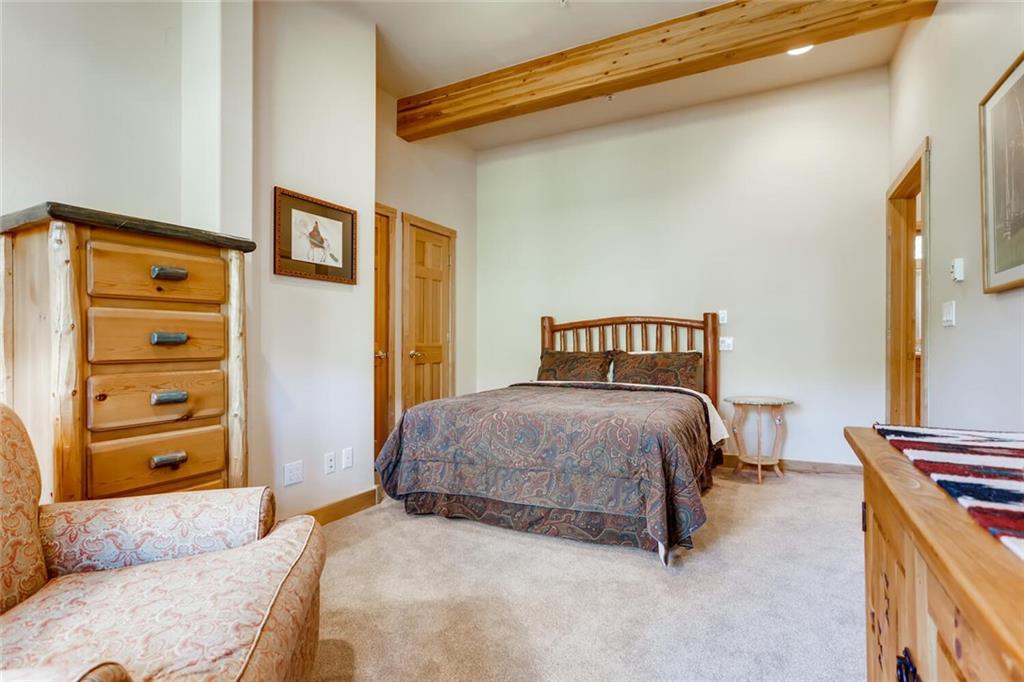 56 River Run Road, Unit 301 Keystone, CO 80435 - Photo 22 of 30 a bedroom with a bed and a dresser
