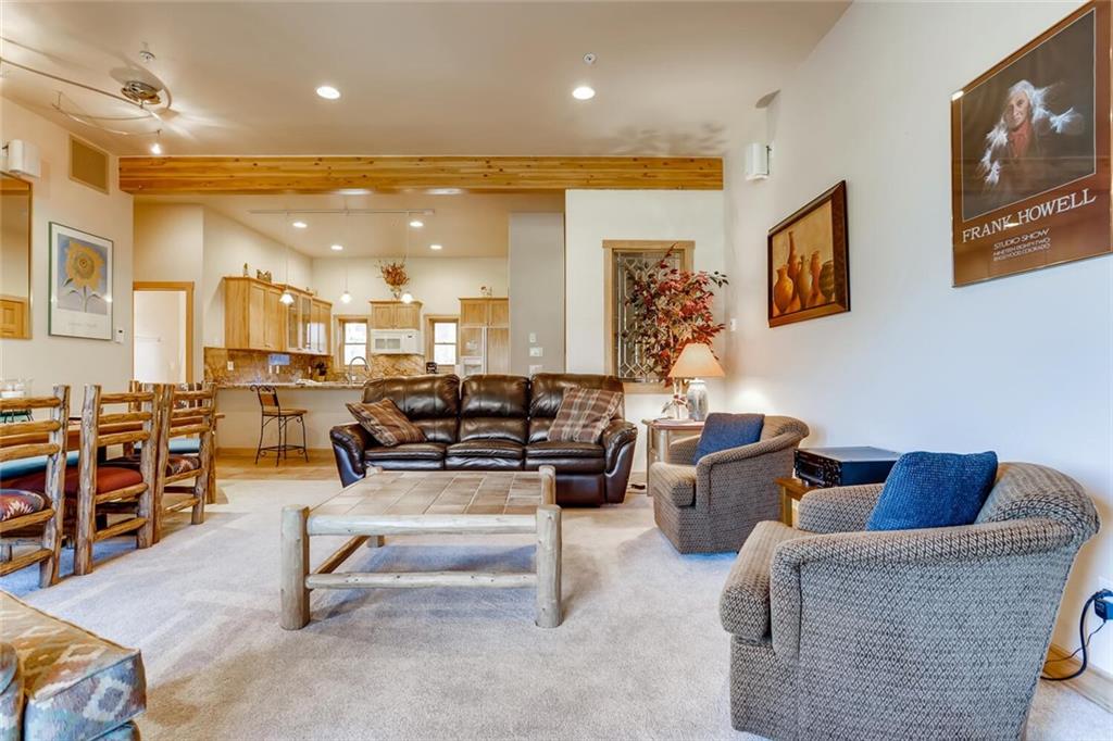 56 River Run Road, Unit 301 Keystone, CO 80435 - Photo 4 of 30 a living room with furniture and a flat screen tv