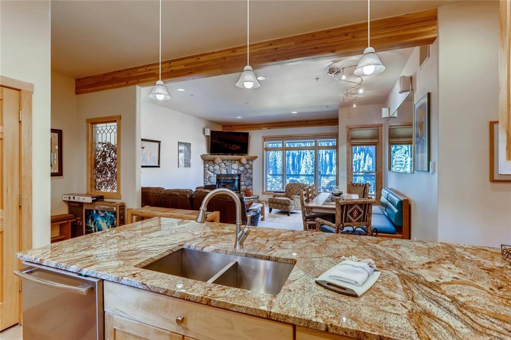 56 River Run Road, Unit 301 Keystone, CO 80435 - Photo 6 of 30 a kitchen with a sink a counter space and living room view