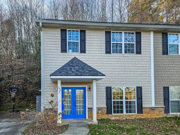 a front view of a house with garden