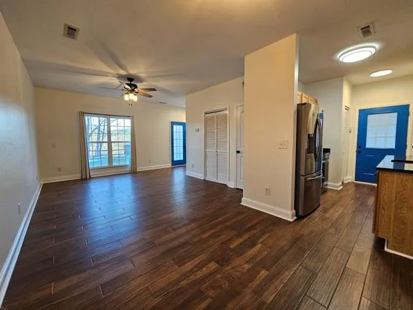 a view of a livingroom with hardwood floor and a ceiling fan