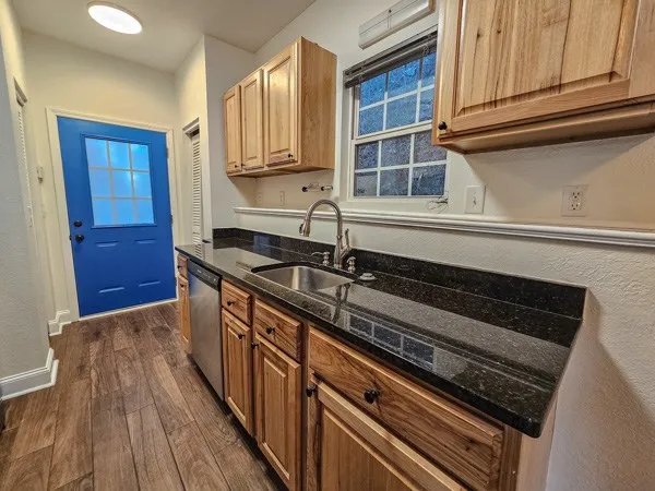 a kitchen with wooden cabinets and a stove top oven