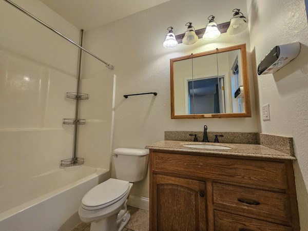 175 Boardtown Road Ellijay, GA 30540 - Photo 23 of 29 a bathroom with a granite countertop toilet sink and mirror