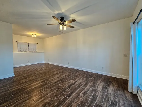 wooden floor in an empty room with a window