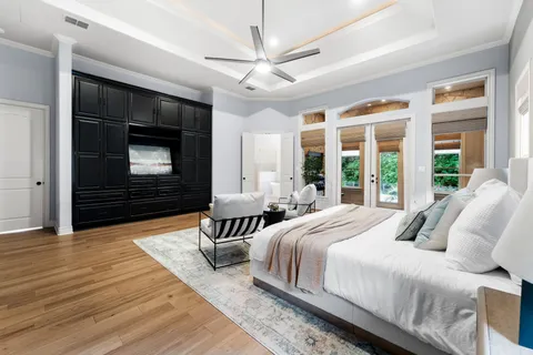 a bedroom with bed and a large window