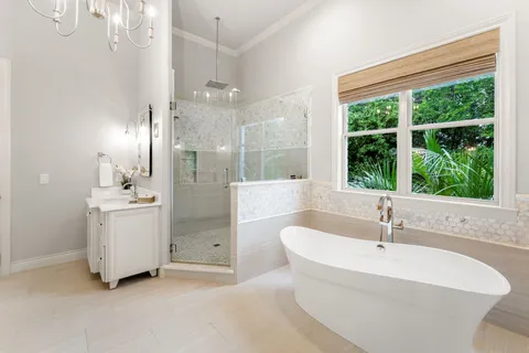 a white bath tub sitting in a bathroom and sink