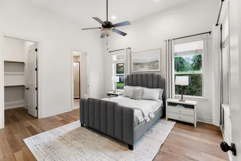 a bedroom with a large bed and a window