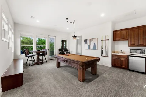 a living room with furniture a dining table and chairs with kitchen view